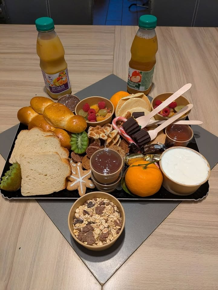 Plateau petit déjeuner gourmand avec viennoiseries, fruits et jus